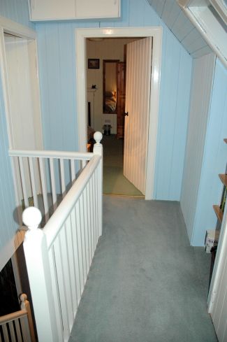 The front door of Bruaich Cottage in Lochcarron opens into the hallway from which there are doors to the kitchen/dining room, the living room and the bathroom. The hall, stairs and landing are pine-clad and tastefully decorated.